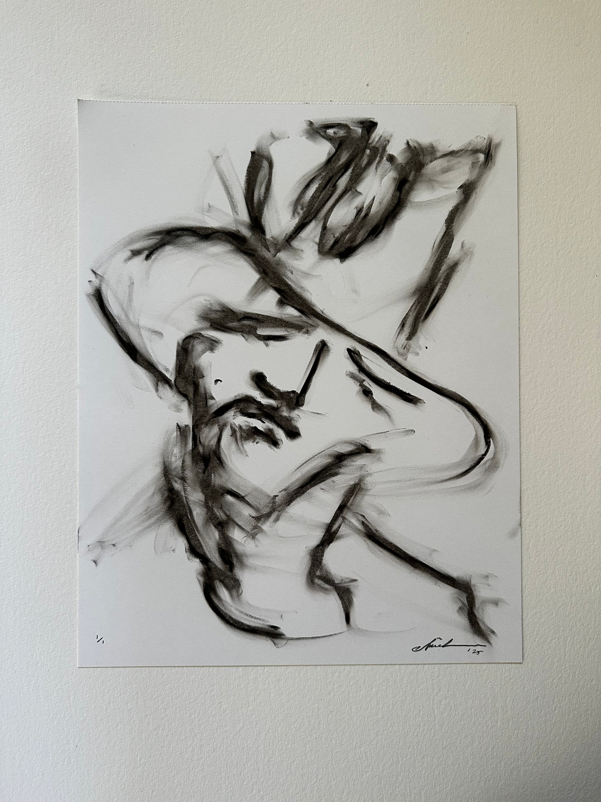 Black drawing of a young cowboy in a wide-brim hat on white paper
