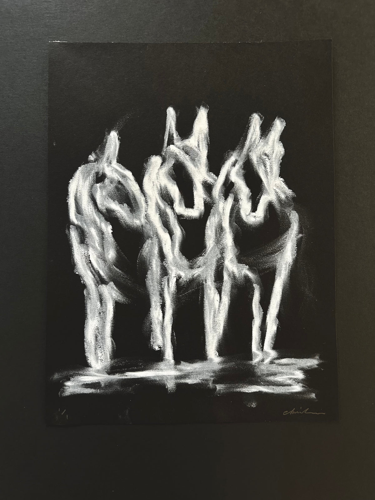 Three horses drawn in white strokes on black