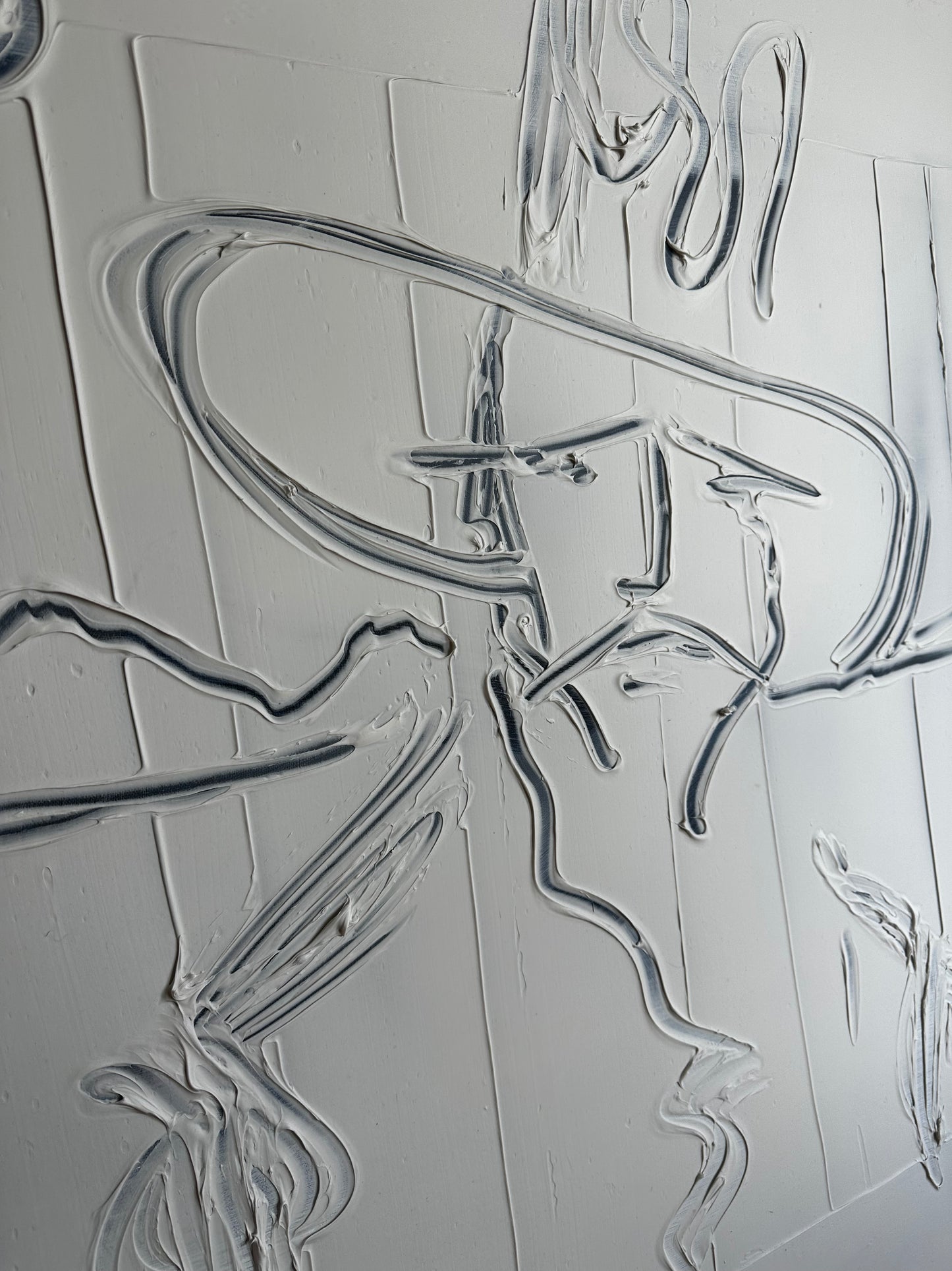 Close-up of the raised molding-paste lines forming a figure in a wide hat