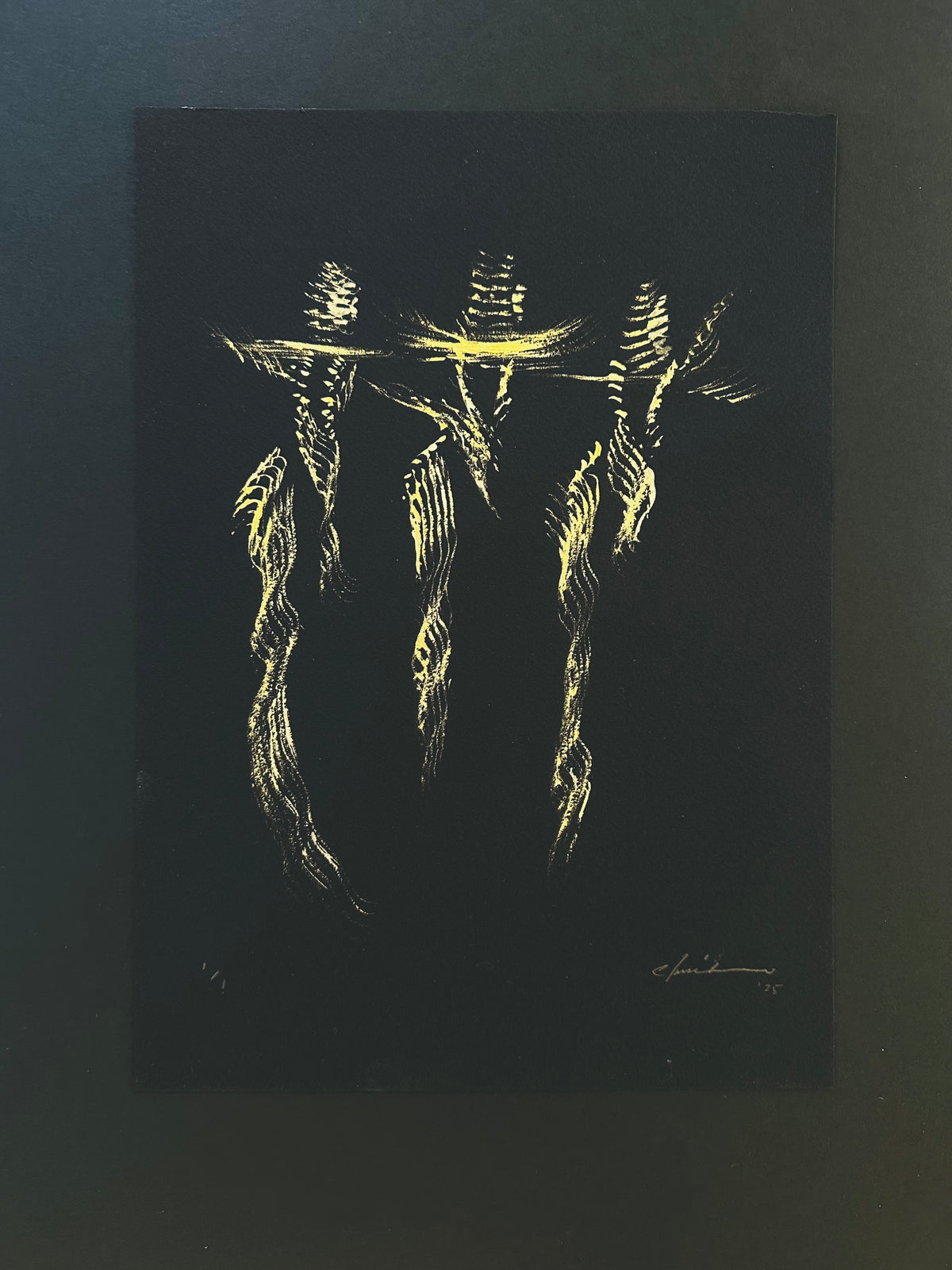 Gold acrylic painting of three cowboys standing side by side on black paper
