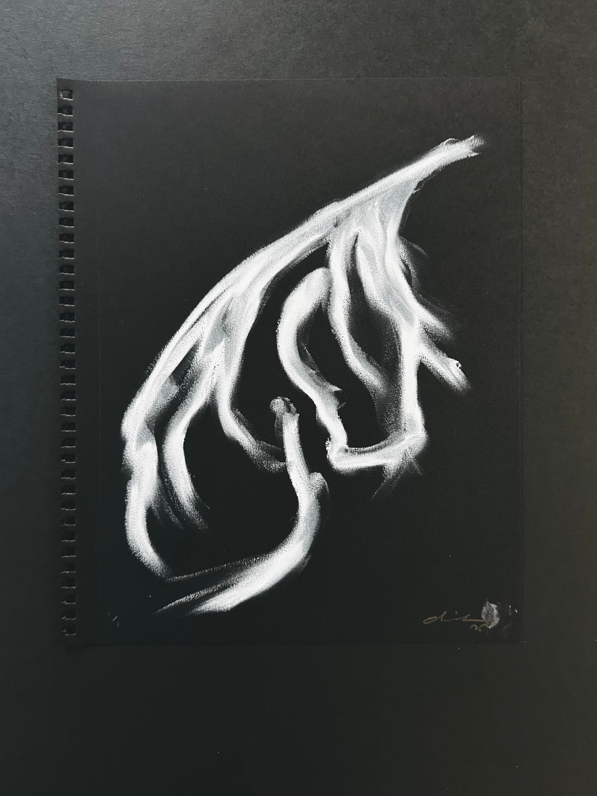 White strokes on black suggesting a woman's flowing hair
