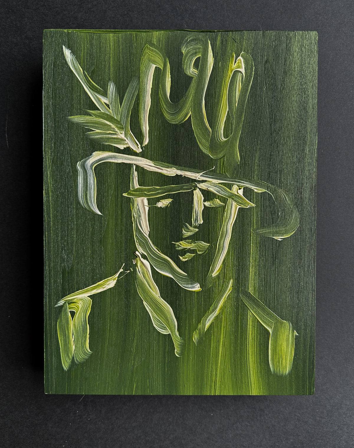 Front view of the green acrylic cowboy portrait on wood panel