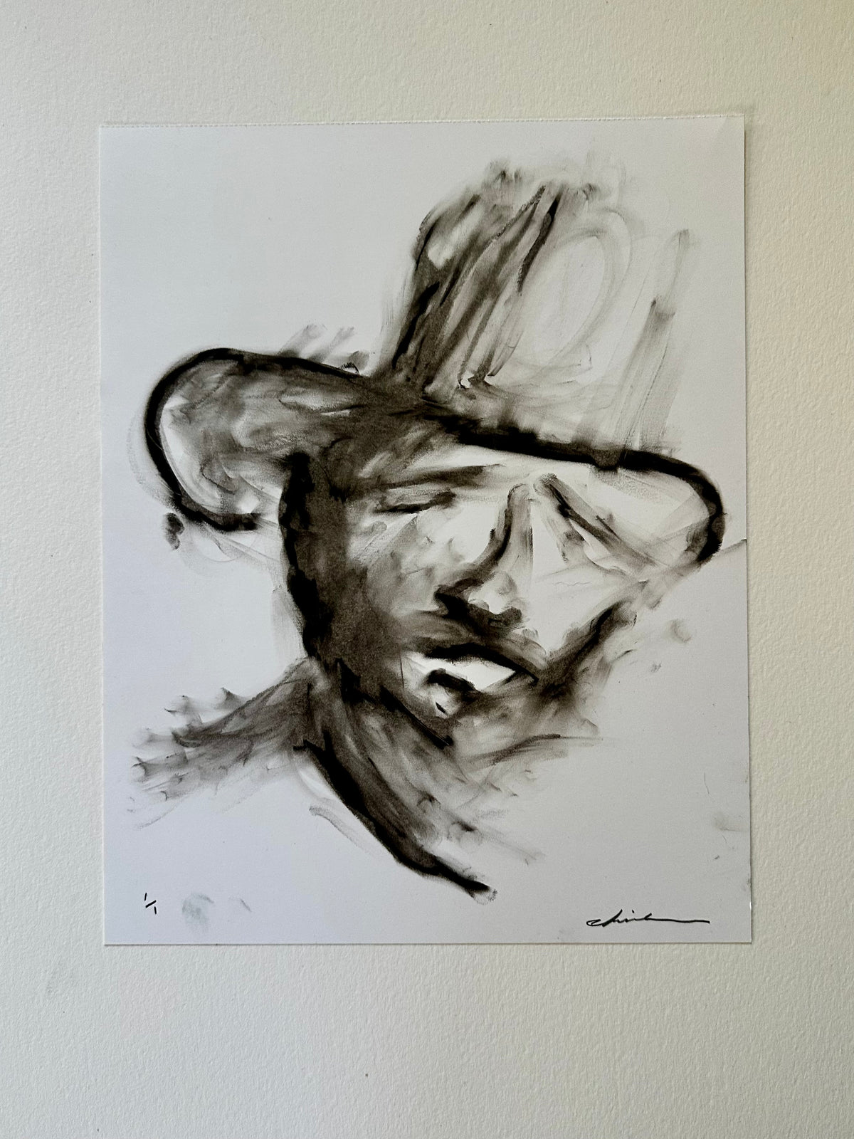 Black oil pastel portrait of a cowboy in a wide-brim hat on white Bristol board